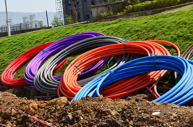 six coils of colorful conduit waiting to be installed underground